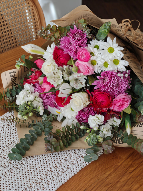 Hand-tied seasonal flower bouquet with roses, daisies, and chrysanthemums, Bloomin & Buddin signature subscription